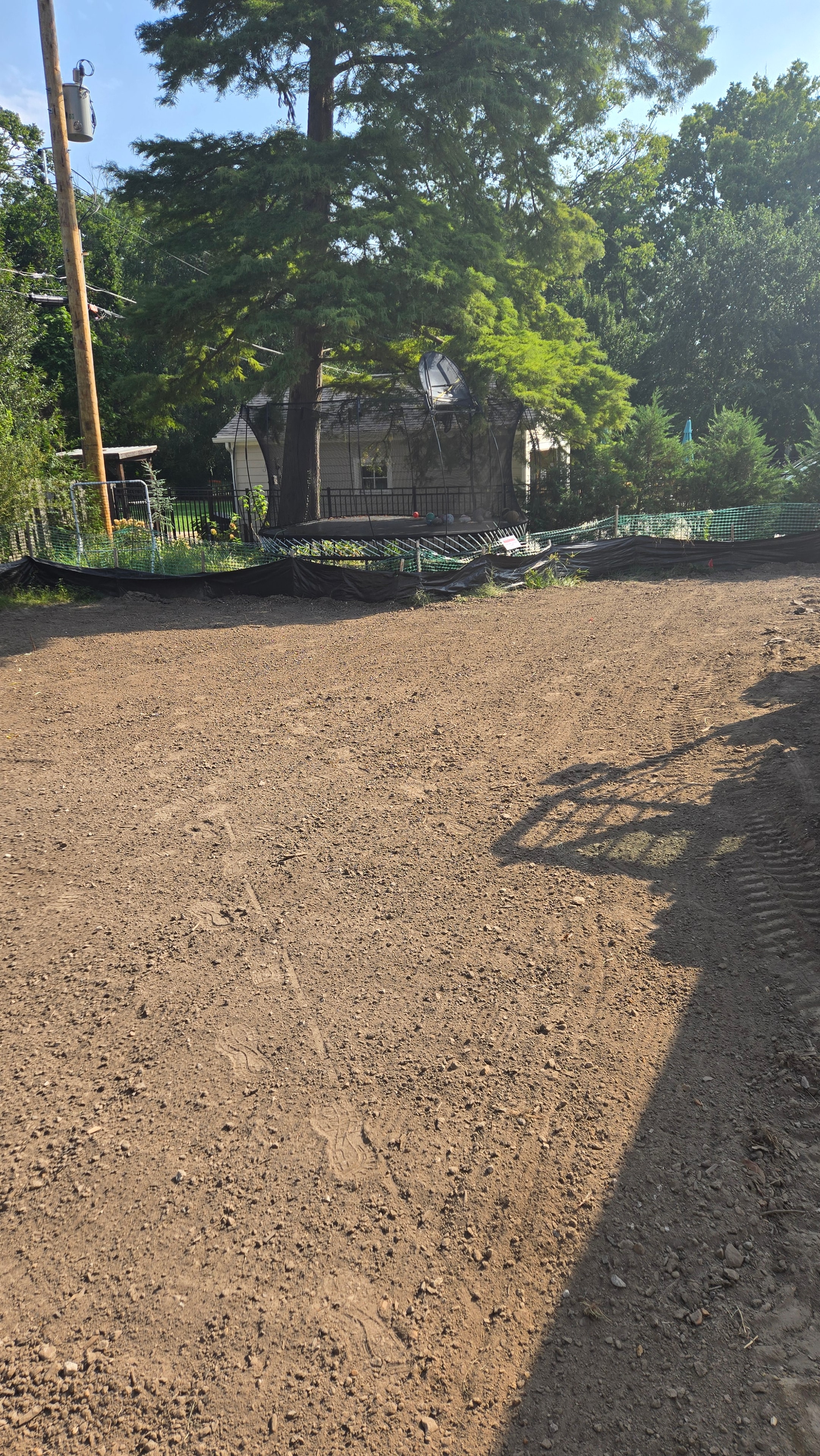 Backyard bare dirt prepped and graded for hydroseeding in Kirkwood, MO