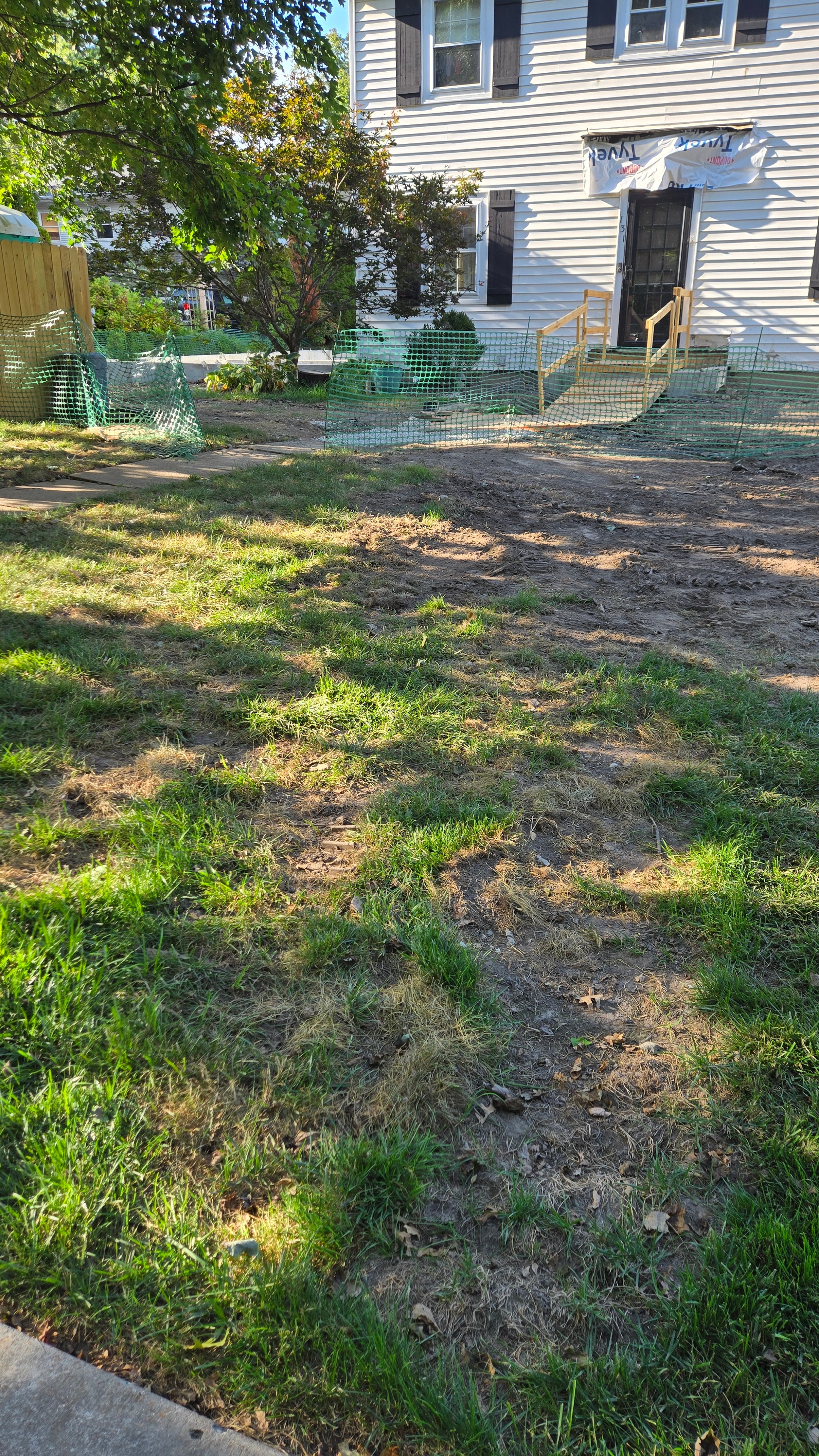 Existing grass next to disturbed soil area before hydroseeding