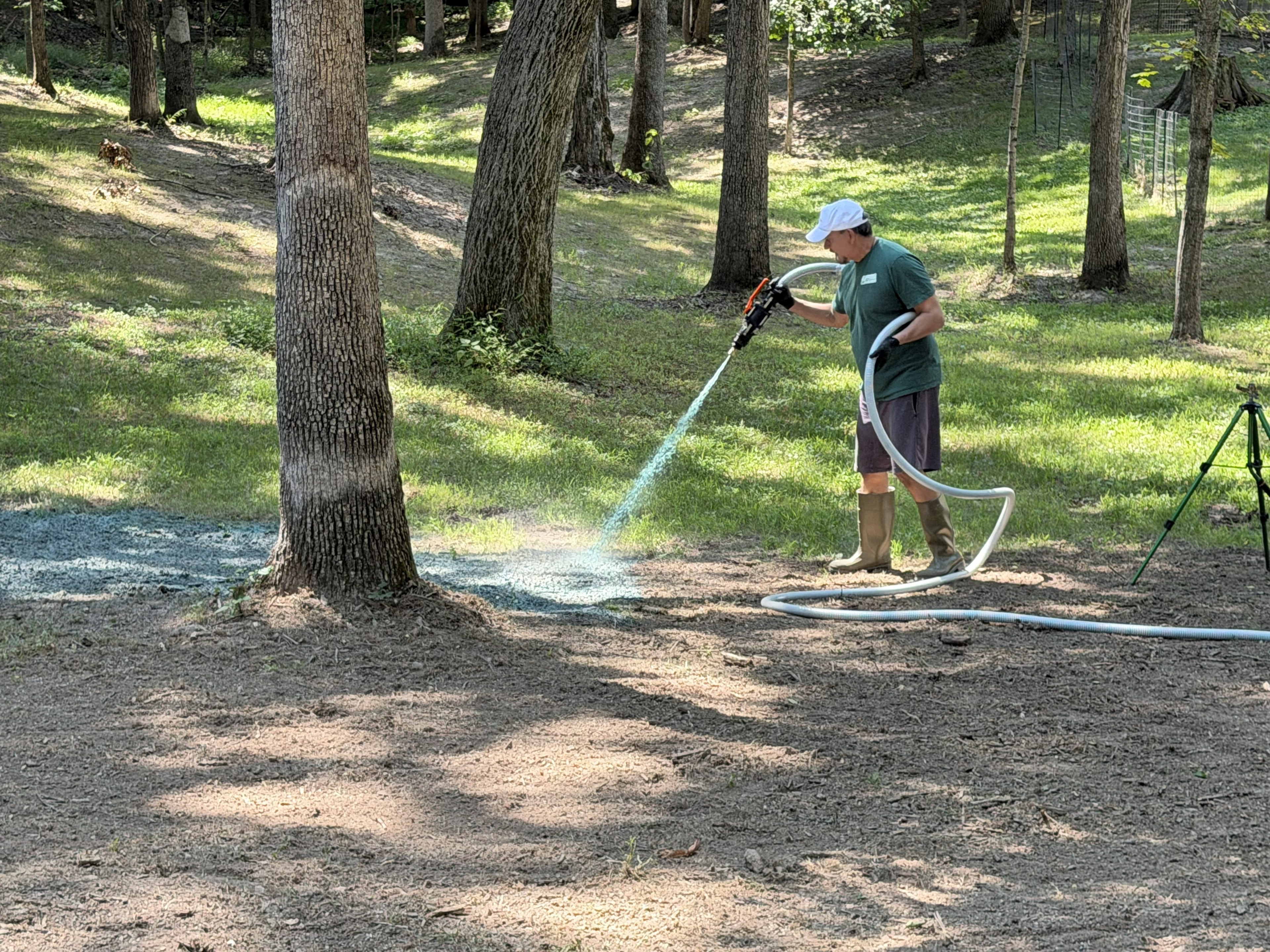 Blue-green hydroseeding slurry covering the prepared yard